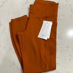 Athleta ultimate stash 7/8 tight.  Never worn. New with tags. side deep pockets.